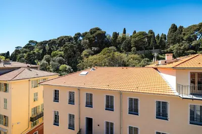 a group of buildings with a mountain in the background at Nice Renting - GAUTIER - Elegance Height Port & Castle Nice in Nice