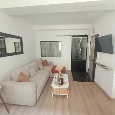 a living room with a couch and a table at Cocooning Atmosphère old Nice in Nice