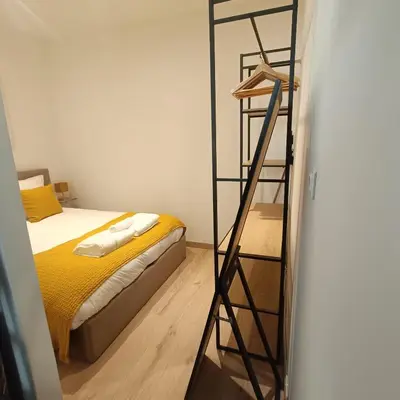 a bedroom with a ladder next to a bed at Cocooning Atmosphère old Nice in Nice