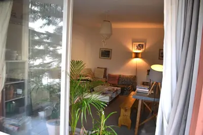 a living room with a couch and a table at Appartement super clair in Nice