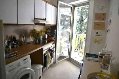 a kitchen with a washing machine and a window at Appartement super clair in Nice