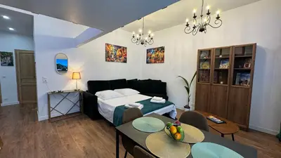 a bedroom with a bed and tables and chairs at Central Riviera Charm in Nice
