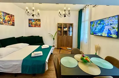 a bedroom with a bed and two tables and a couch at Central Riviera Charm in Nice