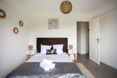 a bedroom with a large bed with towels on it at 4 pièces 8 personnes proche aéroport,tramway in Nice