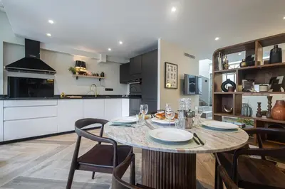 a kitchen and dining room with a table and chairs at Villa fleurie in Cagnes-sur-Mer