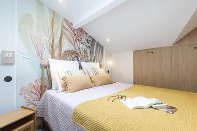 a bedroom with a bed with a book on it at Villa fleurie in Cagnes-sur-Mer