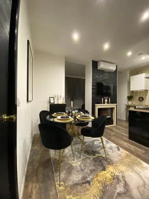 a living room with a table and chairs and a kitchen at Denis&kanya in Nice