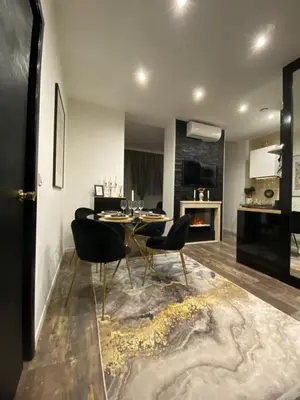 a dining room with a table and chairs and a fireplace at Denis&kanya in Nice