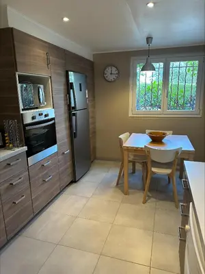 a kitchen with a table and a dining room at Villa de charme 6 Pièces avec Vue Mer sur les Hauteurs de Nice in Nice