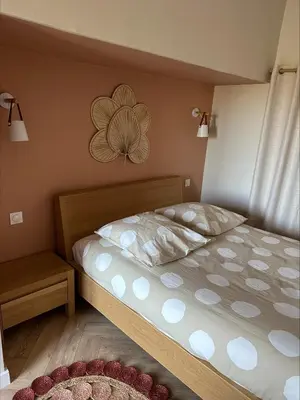 a bedroom with a bed with a flower on the wall at Villa de charme 6 Pièces avec Vue Mer sur les Hauteurs de Nice in Nice