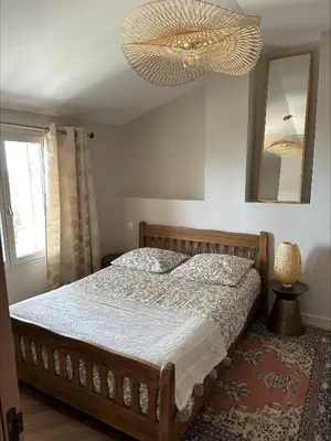 a bedroom with a large bed and a chandelier at Villa de charme 6 Pièces avec Vue Mer sur les Hauteurs de Nice in Nice