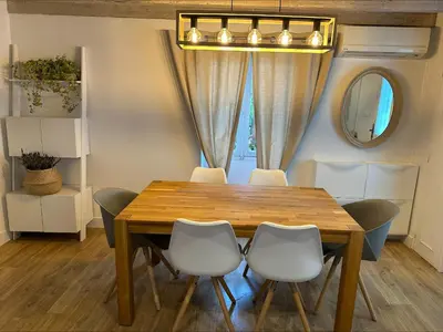 a dining room with a wooden table and chairs at Villa de charme 6 Pièces avec Vue Mer sur les Hauteurs de Nice in Nice