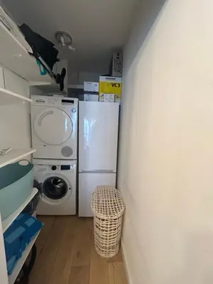 a laundry room with a refrigerator and a washer and dryer at Sunny Days in Nice
