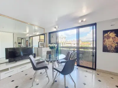 a dining room with a glass table and chairs at Nestor&Jeeves - POP ART - central - balcony in Nice