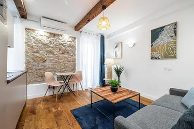 a living room with a couch and a table at Pretty & Quiet Studio in Port Area in Nice