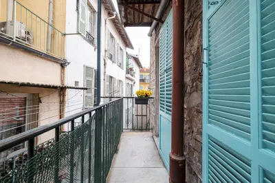 an alley with a flower pot on a balcony at Pretty & Quiet Studio in Port Area in Nice