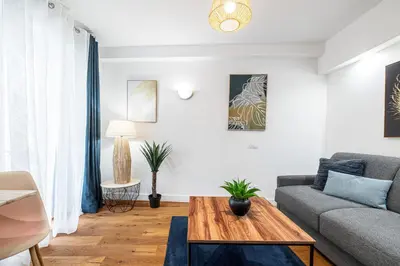 a living room with a couch and a table at Pretty & Quiet Studio in Port Area in Nice