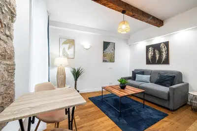 a living room with a couch and a table at Pretty & Quiet Studio in Port Area in Nice