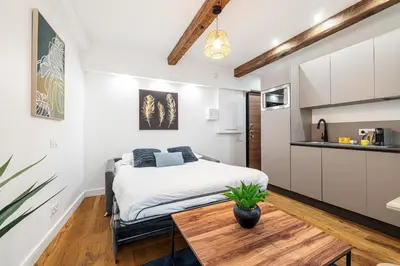 a bedroom with a bed and a table at Pretty & Quiet Studio in Port Area in Nice