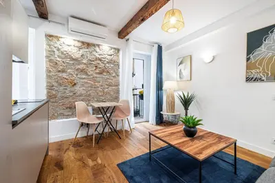 a kitchen and living room with a table and chairs at Pretty & Quiet Studio in Port Area in Nice