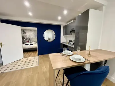 a dining room with a table and blue chairs at Old Town Lovely Apartment in Nice in Nice