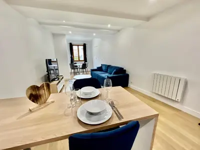 a dining table and chairs in a living room at Old Town Lovely Apartment in Nice in Nice