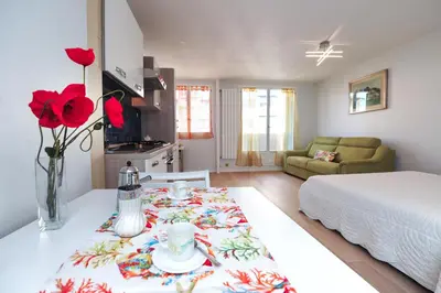 a living room with a table and a bed and a room at Blue Lagon Five Stars Holiday House in Nice
