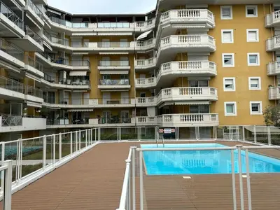 a large apartment building with a swimming pool in front of it at Charming Studio with pool & balcony -Heart of Nice in Nice