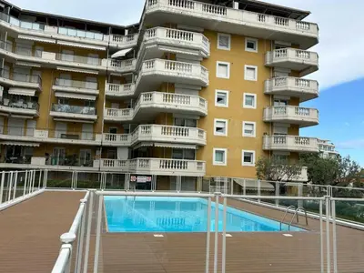an apartment building with a swimming pool in front of it at Charming Studio with pool & balcony -Heart of Nice in Nice