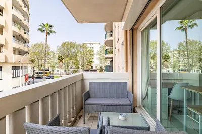 a balcony with a chair and a table at Charming Studio with pool & balcony -Heart of Nice in Nice