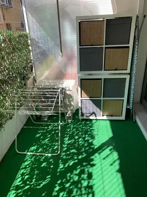 a shopping cart on a green floor next to a building at Appartement Nice Magnan in Nice