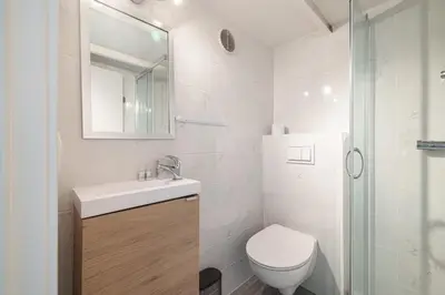 a white bathroom with a toilet and a sink at MY CASA - SIAGRE 35 - Near main Avenue with AC in Nice