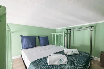 a bedroom with a bed with blue and green walls at MY CASA - SIAGRE 35 - Near main Avenue with AC in Nice