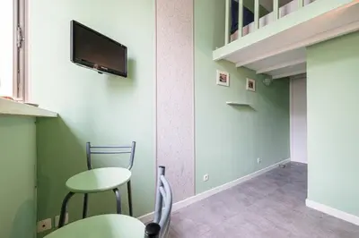 a room with two chairs and a tv on the wall at MY CASA - SIAGRE 35 - Near main Avenue with AC in Nice