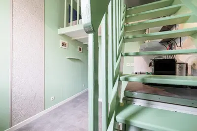 a staircase in a home with green walls at MY CASA - SIAGRE 35 - Near main Avenue with AC in Nice