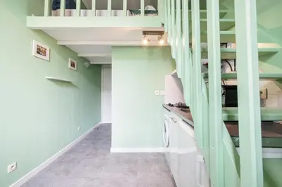 a kitchen with green walls and a spiral staircase at MY CASA - SIAGRE 35 - Near main Avenue with AC in Nice