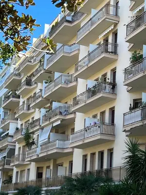 an apartment building with balconies and trees at Nice center Aviva's-home in Nice