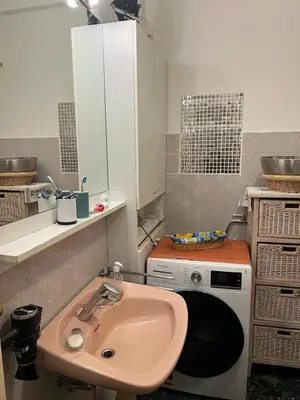 a bathroom with a sink and a microwave at Nice center Aviva's-home in Nice