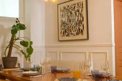 a table with wine glasses and a potted plant at Le Grand Ruisseau in Nice
