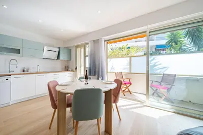 a kitchen and dining room with a table and chairs at Magnifique T2, parking, face mer in Cagnes-sur-Mer