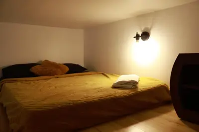 a bedroom with a bed and a light on the wall at Appartement Cosy Centre Nice in Nice