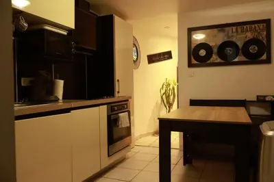 a kitchen with a counter and a table in it at Appartement Cosy Centre Nice in Nice