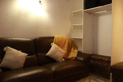 a brown leather couch sitting in a living room at Appartement Cosy Centre Nice in Nice