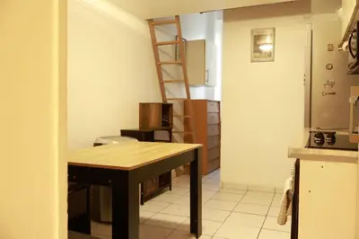 a kitchen with a table and a ladder in it at Appartement Cosy Centre Nice in Nice