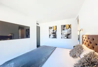 a bedroom with a bed and two pictures on the wall at Nestor&Jeeves - LE ROYAL LUXEMBOURG - Sea view - Terrace in Nice