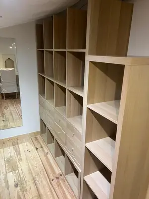a closet with wooden shelves and a mirror at Duplex quatre pièces - une chambre bébé à 5 minutes de la plage in Nice