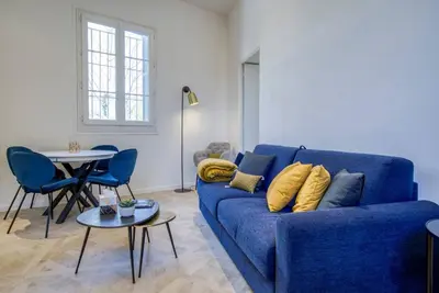 a living room with a blue couch and a table at 4 stars Palais Hermitage, 5 pers, AC, Full confort in Nice
