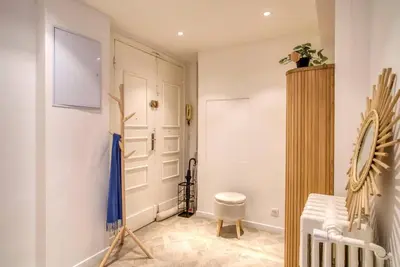 a room with a white door and a stool at 4 stars Palais Hermitage, 5 pers, AC, Full confort in Nice