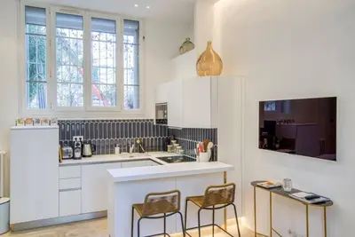 a kitchen with a counter and two chairs in it at 4 stars Palais Hermitage, 5 pers, AC, Full confort in Nice
