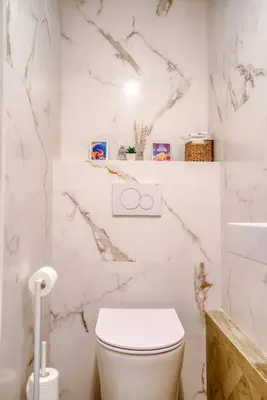 a white bathroom with a toilet and a sink at 4 stars Palais Hermitage, 5 pers, AC, Full confort in Nice
